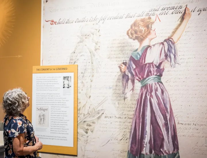 Woman admires graphic of woman painting 