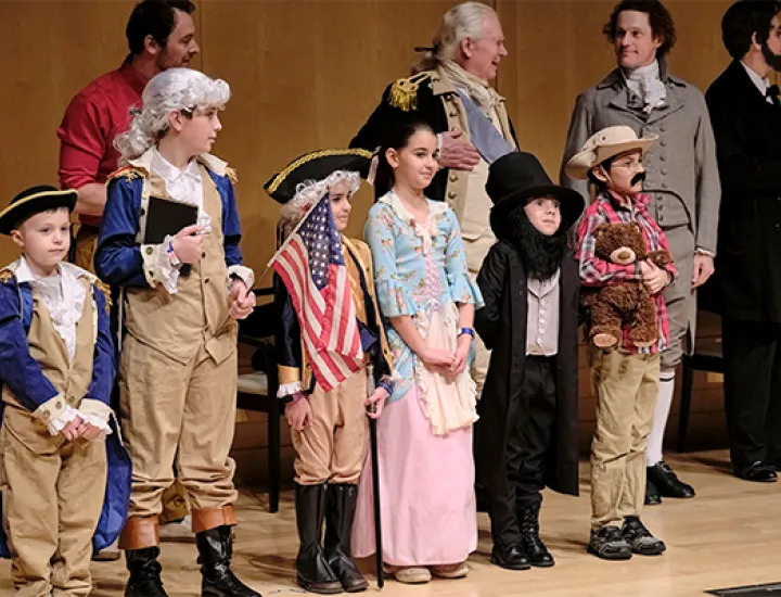A group of children dressed in historical costumes representing America's presidents and first ladies.