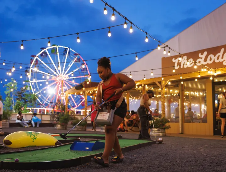 A person mini-golfing