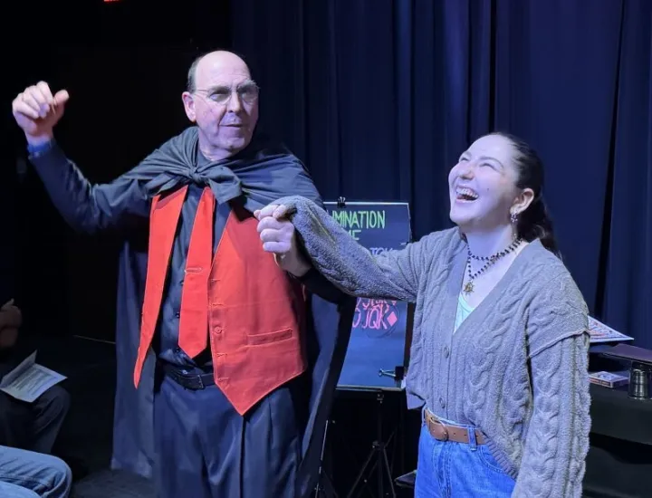 Woman smiling reacting to a magic trick