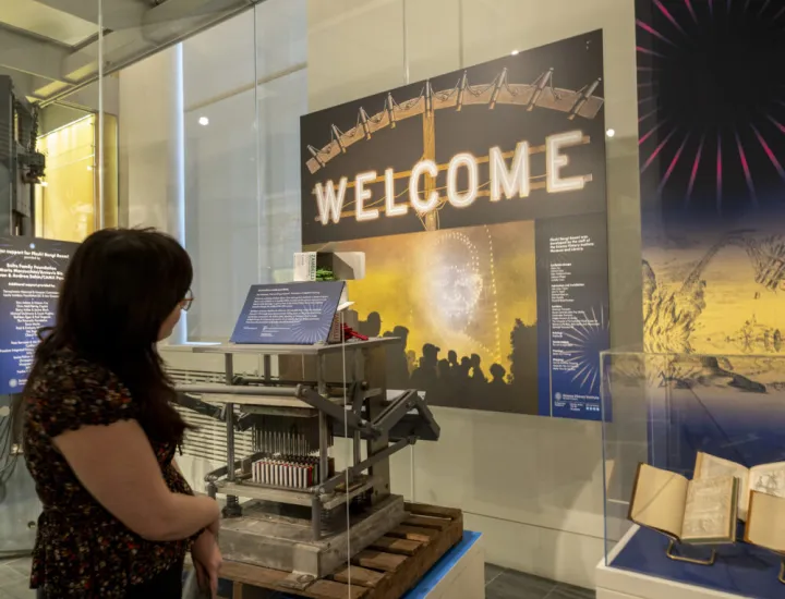 woman viewing an exhibition on fireworks history