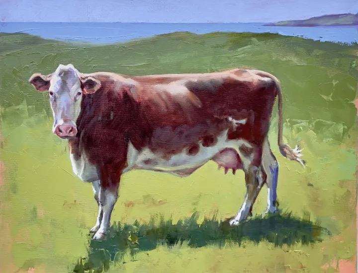 A red and white cow stands demurely in a vivid green field, a glimpse of the Irish Sea beyond. “Irish Cow” oil on canvas 16 x 20 inches 2026