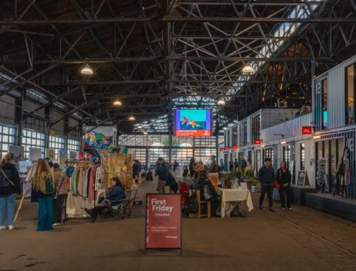 This photo depicts the interior of Cherry Street Pier in Philadelphia during a "First Friday" event.The pier is a repurposed municipal shipping pier featuring converted shipping container artist studios and public market spaces.