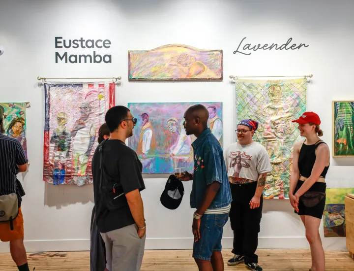 Crowd viewing artwork by Eustace Mamba
