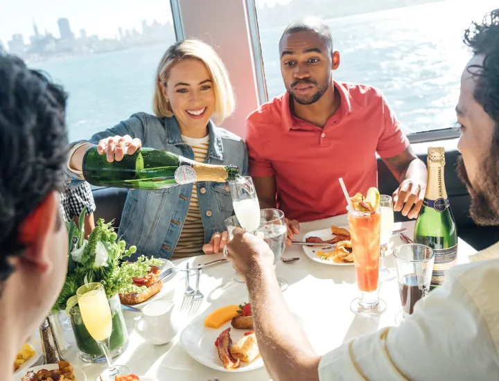 Guests pouring champagne on boat