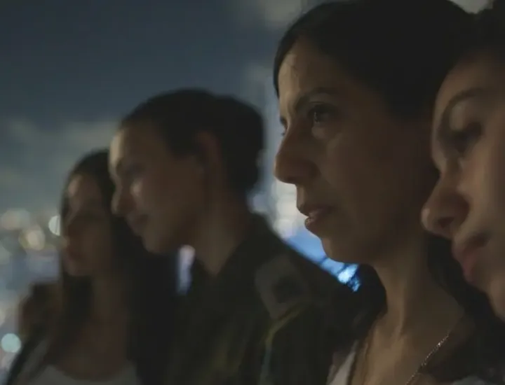Still from the movie of 4 people looking over a city